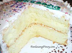 a cake with white frosting and colorful sprinkles on it's edges