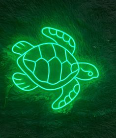 a neon green turtle is glowing in the dark