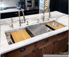 a kitchen with marble counter tops and stainless steel sinks