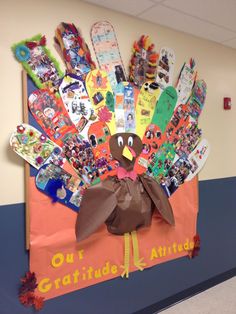 a bulletin board with a turkey made out of books on it's front wall