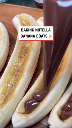 banana boats with chocolate spread on them sitting on a cutting board