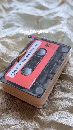 an old - fashioned cassette book is sitting on a bed