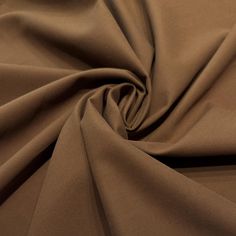 a close up view of the fabric on a plain brown shirting material that is very soft