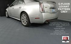 a silver cadillac parked in a garage with the words g - floor levient pattern grey