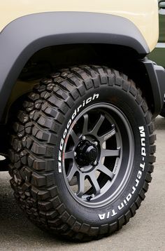 an off - road vehicle is parked on the pavement with its wheels and tire rims