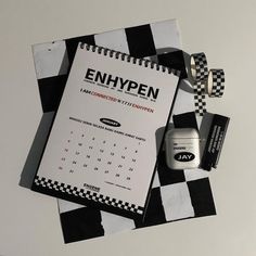 an open notebook sitting on top of a checkered table cloth