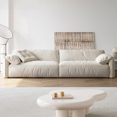 a living room with a white couch and coffee table