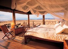 a large bed sitting in the middle of a bedroom