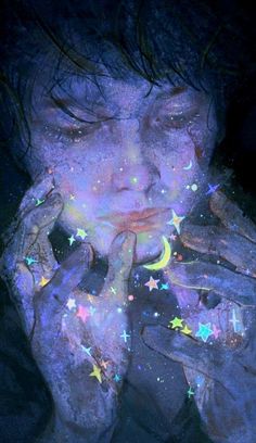 a woman with her hands on her face covered in stars and glows from the dark