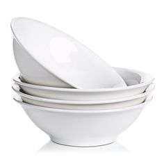 four white bowls stacked on top of each other