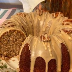 a bundt cake with frosting and nuts on top