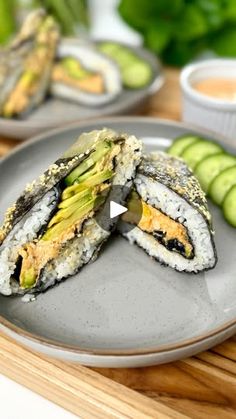 sushi on a plate with cucumbers in the background