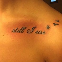 the back of a woman's shoulder that says still rise with birds flying around it