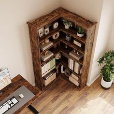 an overhead view of a book shelf in the corner of a room with a desk and computer on it