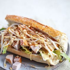 a sandwich with meat, cheese and lettuce on a plate