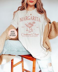 "This Margarita Cocktail Club shirt is the perfect birthday gift or Christmas gift for all women! All of our shirts are made with the highest quality materials and are super soft and cozy! 💚 HOW TO ORDER 💚 1. Check our photos for sizing and color options. 📏 2. Choose your quantity.  Feel free to add as many shirts as you wish! ✨ 3. Select your size and color from the drop-down menus. ✨ 4. Click \"ADD TO CART\" to add the shirt to your virtual cart. 🛒 5. Click \"PROCEED TO CHECKOUT\" to purch Drinking Night, Margarita Shirt, Margarita Cocktail, Cocktail Club, Oversize Shirt, Club Shirts, The Perfect Birthday, Comfort Colors Tee, Perfect Birthday Gift