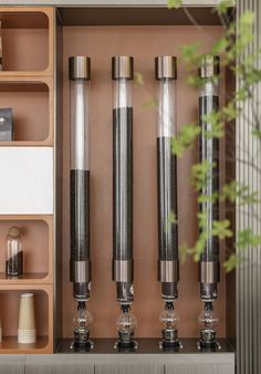 a shelf with three different types of vases and other items on it's shelves