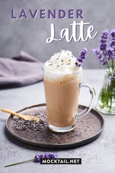 lavender latte with whipped cream in a glass mug