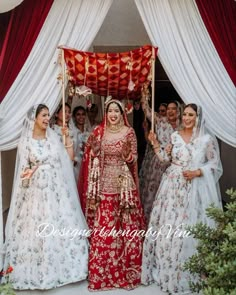 a group of women standing next to each other under a canopy