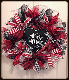 a red and black mesh wreath with a heart on it that says, be mine