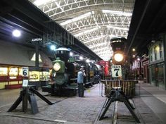 there is a train that is on display at the station and people are standing near it