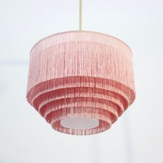 a pink chandelier hanging from a ceiling