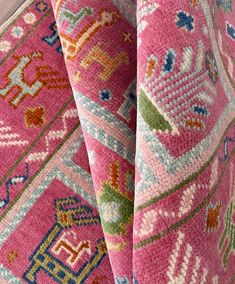 close up view of pink rugs with colorful patterns