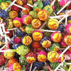 a pile of assorted candy lollipops sitting on top of each other