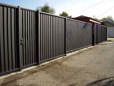 a black fence is next to a building