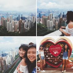 two girls are standing on top of a building and one is holding a heart shaped object