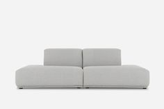 a gray couch sitting on top of a white floor