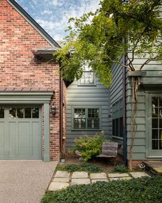 a brick house with two garages on each side