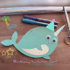 a birthday card with a narwhale on it and some scissors next to it