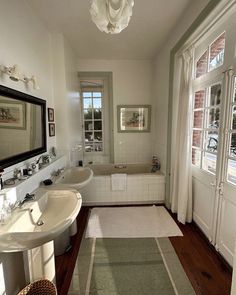 a bathroom with two sinks and a bathtub