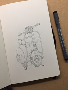 a drawing of a scooter on a notebook