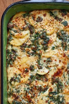 a casserole dish with spinach, cheese and other toppings on it