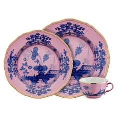 two pink and blue plates with matching cups