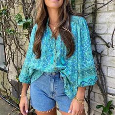 Gorgeous Blue Boho Floral Printed Button Up V-Neckline Blouse With Tassel Fringed Tie And Wide Elastic Hemmed Sleeves. Size Fit: Small: 2-4 Medium: 4-6 Large: 6-8 Material: 100% Viscose Measurements: Small: Bust: 37" Sleeve: 23.2" Length: 28.74" Medium: Bust: 38.5" Sleeve: 23.6" Length: 29.1" Large: Bust: 40.1" Sleeve: 24" Length: 29.5" Our Boutique Is Filled With A Curated Collection Of Styles: Spell Gypsy Boho Bohemian Hippie Retro Vintage Handmade Coachella Festival Free People Anthropologie Bohemian Spring Blouse With Buttons, Spring Bohemian Blouse With Buttons, Casual Turquoise V-neck Blouse, Bohemian Beach Blouse With Buttons, Bohemian Blouse With Buttons For The Beach, Blue V-neck Tops With Buttons, Green V-neck Blouse With Buttons, Bohemian Button-up Blouse For Vacation, Blue Buttoned Blouse For Summer