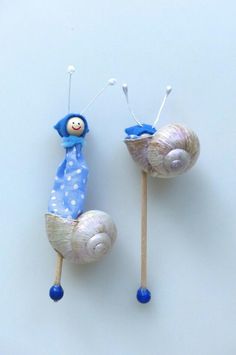 two snails are sitting on top of each other, one is blue and the other is white