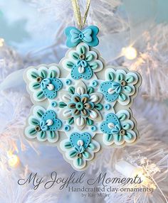 a blue and white ornament hanging from a christmas tree