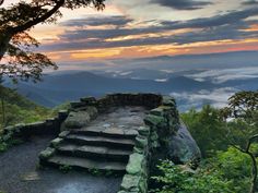 the steps lead up to the top of the mountain at sunset or sunrise in the distance