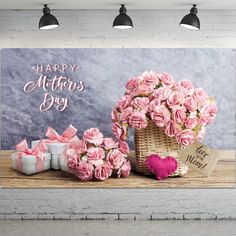 pink flowers in a wicker basket and presents on a wooden table with a happy mother's day sign