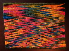 a multicolored rug on a wooden table