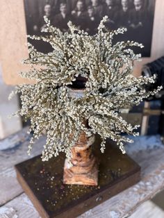 a vase filled with white flowers on top of a wooden table