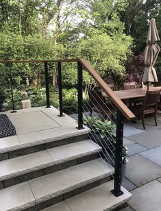 an outdoor patio with stairs and tables