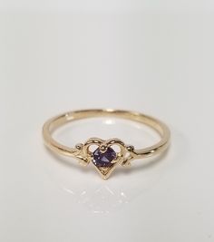 "Thanks for shopping our vintage estate store. We tend to sell well below wholesale and truly hope you enjoy all of our items. Many of the items are one of a kind, so please enjoy scrolling through the pictures and hopefully something will catch your eye. Spots are from reflections or camera. Estate 14k yellow gold created .10ct alexandrite heart ring. The color of the gem is blue, green, to purple. No scratches on the gem. Stunning. Bought out a jewelry store that was closing and these were lef Classic 14k Gold Heart-shaped Birthstone Ring, Heart-shaped 14k Gold Birthstone Ring, Heirloom Heart Ring With Birthstone For Valentine's Day, Valentine's Day Heirloom Heart Ring With Birthstone, Vintage Gold Amethyst Birthstone Ring, Classic 14k Gold Birthstone Ring For Valentine's Day, 14k Gold Heart Ring With Birthstone, Valentine's Day Classic 14k Gold Birthstone Ring, Classic 14k Gold Heart Ring With Gemstone