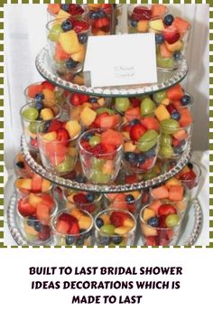 a triple layer tray filled with lots of different types of fruit on top of each other