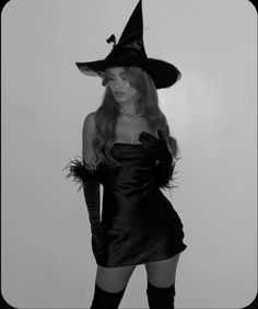 a woman in a witch costume posing for the camera