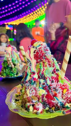 an ice cream sundae on a plate covered in candy and sprinkles