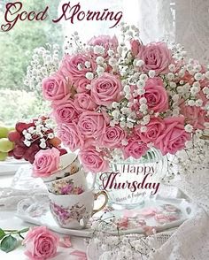 pink roses and baby's breath in a teacup on a table with lace